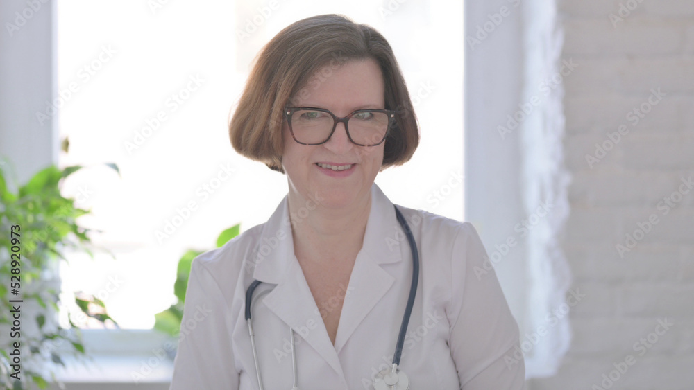 Senior Female Doctor Shaking Head as Yes Sign, Approval Senior Female Doctor Shaking Head as Yes Sign, Approval