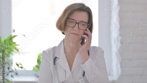 Portrait of Senior Female Doctor Talking on Phone