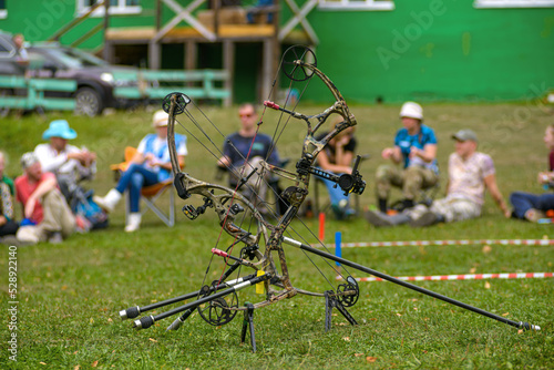 professional archer shooting with modern longbow in forest © photollurg