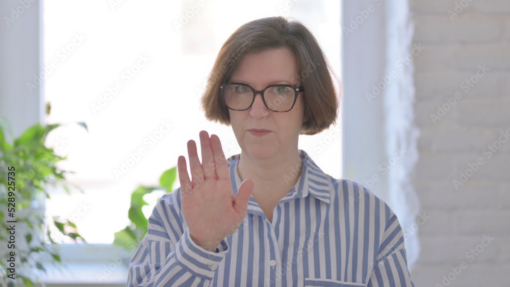 Denying Senior Woman Showing Stop Sign Denying Senior Woman Showing Stop Sign