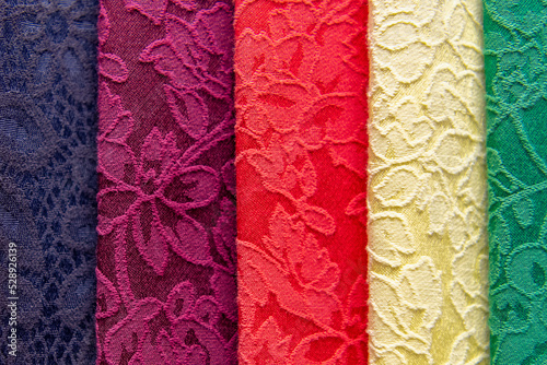 Bilde på lerret Samples of colored brocade fabrics in selective focus