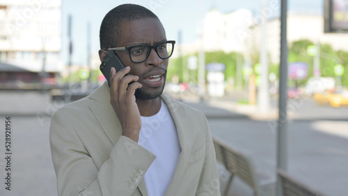 Portrait of African Man Talking on Phone Outdoor