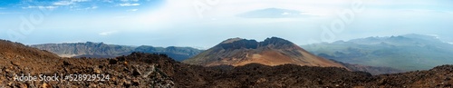 Pico Viejo volcano where the island of La Gomera can be seen in the background, image taken from a viewpoint on Teide, Tenerife, Spain.