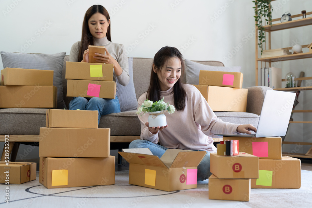 Partnership of SME entrepreneur teamwork of small business online marketing with packing box prepare for deliverty to customers at warehouse home seller office.