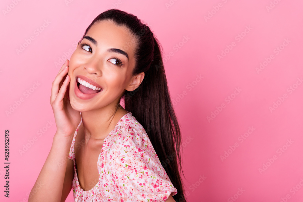 Profile photo of excited pretty person arm touch cheekbone look empty space isolated on pink color background