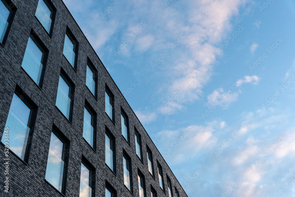 Modern unrecognised buildings with sunset sky reflected in window glasses Modern unrecognised buildings with sunset sky reflected in window glasses