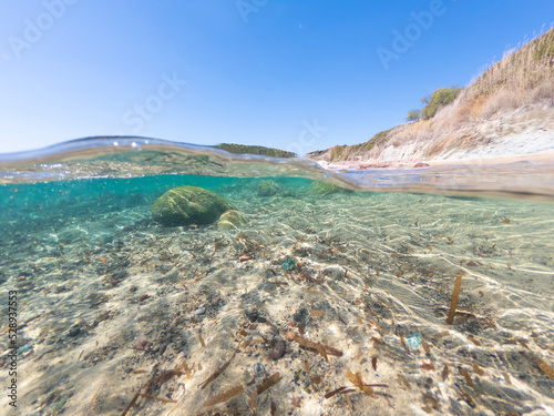 Split underwater view of La Speranza beach on a sunny day