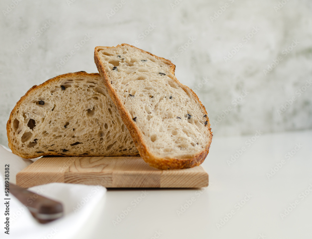 Sourdough bread with black olives on the white background. Copy space for text Sourdough bread with black olives on the white background. Copy space for text