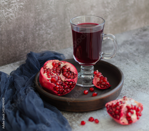 Pomegranate and pomegranate juice on a earthenware 