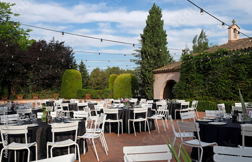Fototapet Outdoor venue with dinner tables before event
