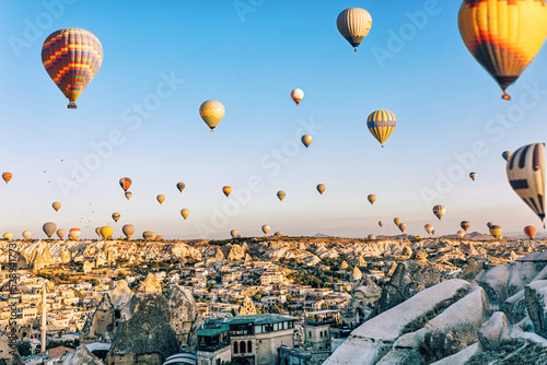 Hot air balloons fly over Cappadocia, panoramic wide view background