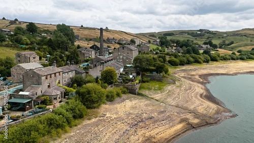 Aerial drone footage of a typical rural Yorkshire Village. Shot at Leeming reservoir  above Oxenhope and adjacent to Leeming Reservoir near Haworth in the heart of West Yorkshire's Bronte Country . photo