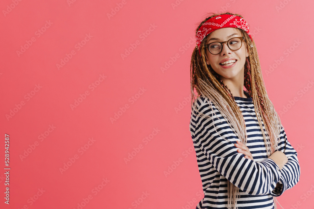 White woman with dreadlocks smiling while looking aside White woman with dreadlocks smiling while looking aside