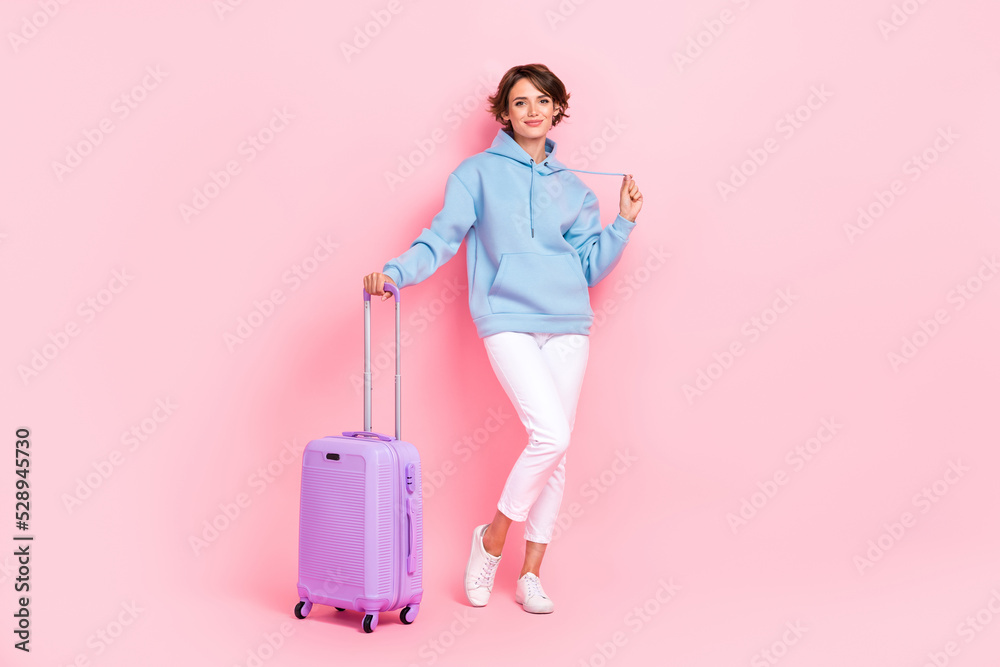 Full length body size view of pretty cute fit girl holding bag departure posing empty space isolated on pink color background Full length body size view of pretty cute fit girl holding bag departure posing empty space isolated on pink color background