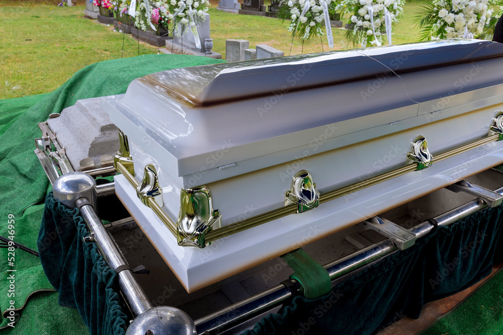 As part of the funeral service in a cemetery, coffin is placed on an