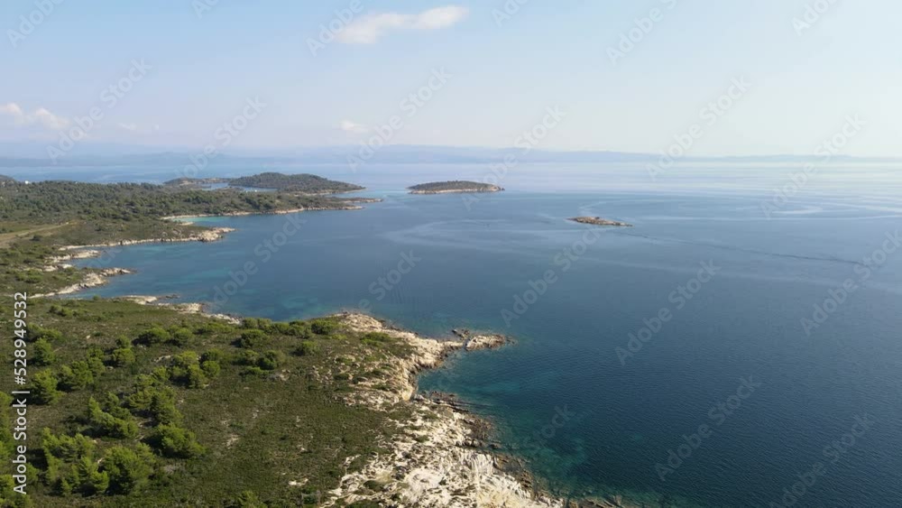 Flying over island with beautiful blue water, aerial view of Diaporos Island in Greece Flying over island with beautiful blue water, aerial view of Diaporos Island in Greece