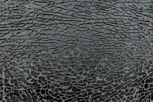 abstract background of cracked dark glass texture