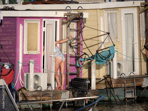 girl entering in a colorful houseboat