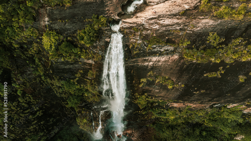 Natural Landscape with a huge waterfall from the mountains, green hills and jungle, Diyaluma in Sri Lanka.