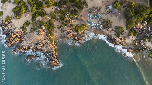 Ocean tropical landscape, rocky coast with fishing boats, drone shot, water and beach. photo