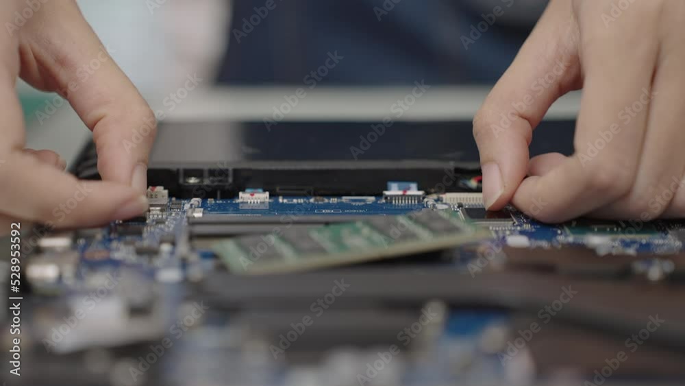 Close up hand of woman removing RAM random access memory from notebook or laptop. Fixing or repair computer. Close up hand of woman removing RAM random access memory from notebook or laptop. Fixing or repair computer.