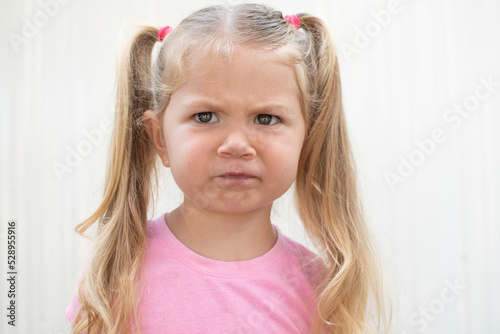 Portrait of a caucasian child with sceptic face expression. 