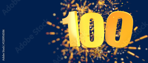 Gold number 100 in the foreground with gold confetti falling and fireworks behind out of focus