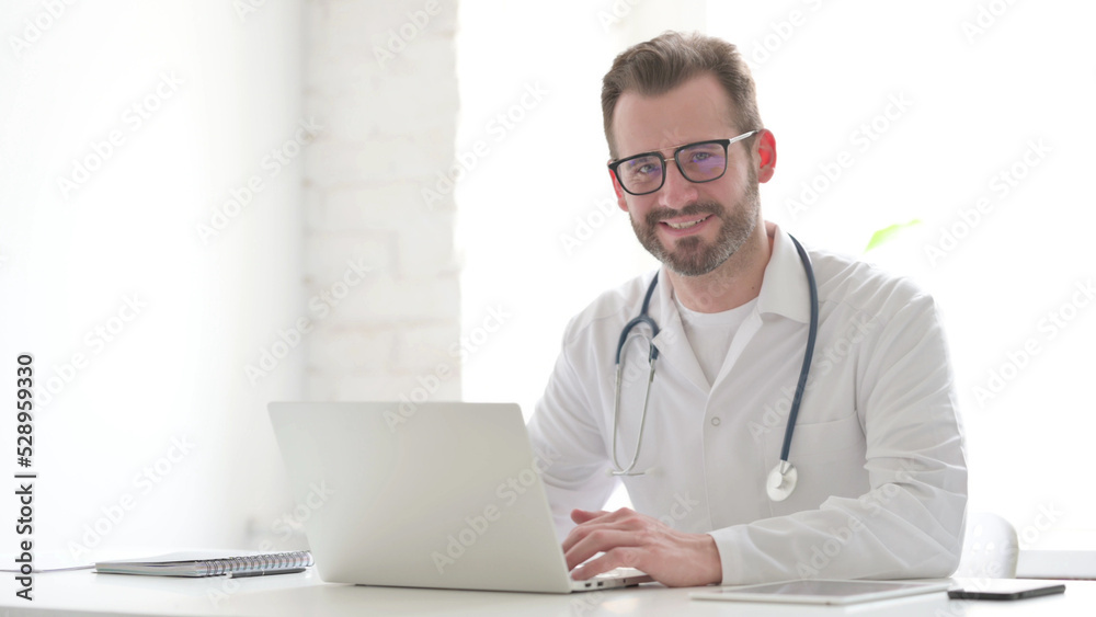 Doctor with Laptop Shaking Head as Yes Sign Doctor with Laptop Shaking Head as Yes Sign