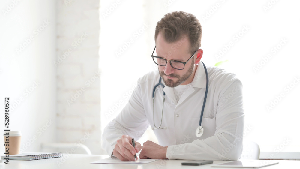 Doctor Writing on Paper in Clinic Doctor Writing on Paper in Clinic
