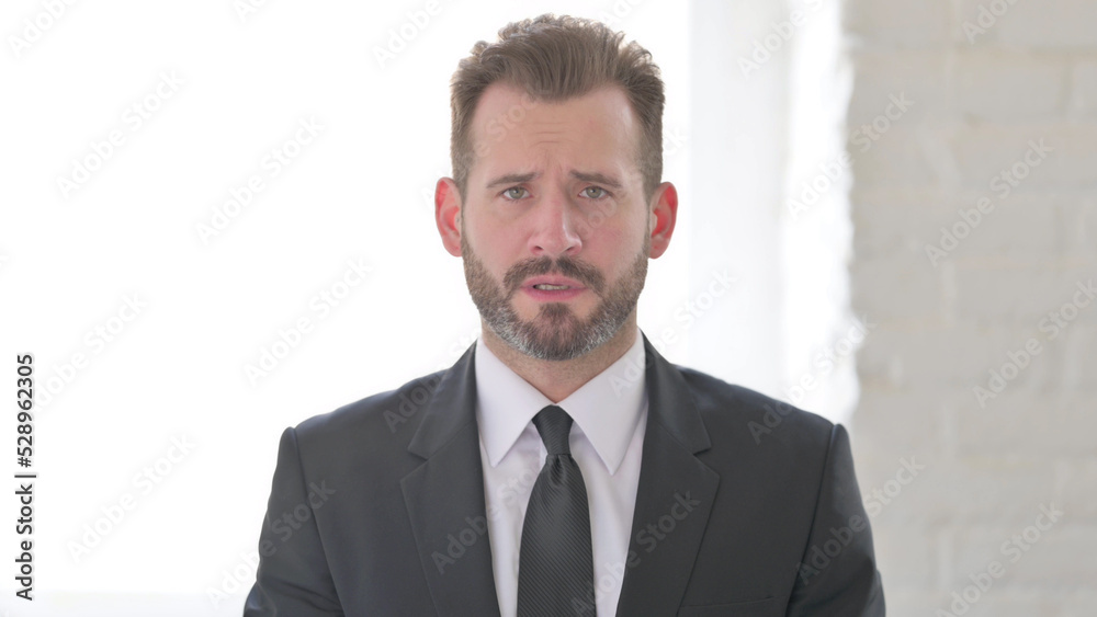 Middle Aged Businessman Looking at the Camera, Sad Expression Middle Aged Businessman Looking at the Camera, Sad Expression