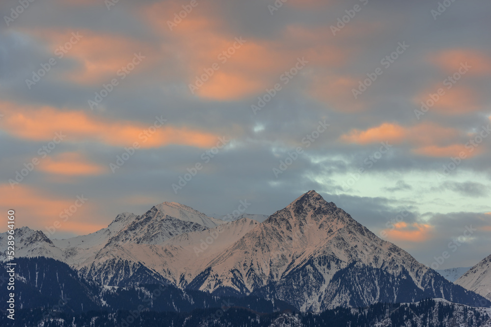 Snow-covered mountain range and picturesque early sky