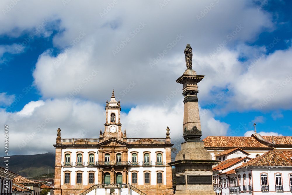 View of houses and monument around the central square of Ouro Preto, State of Minas Gerais, Brazil.