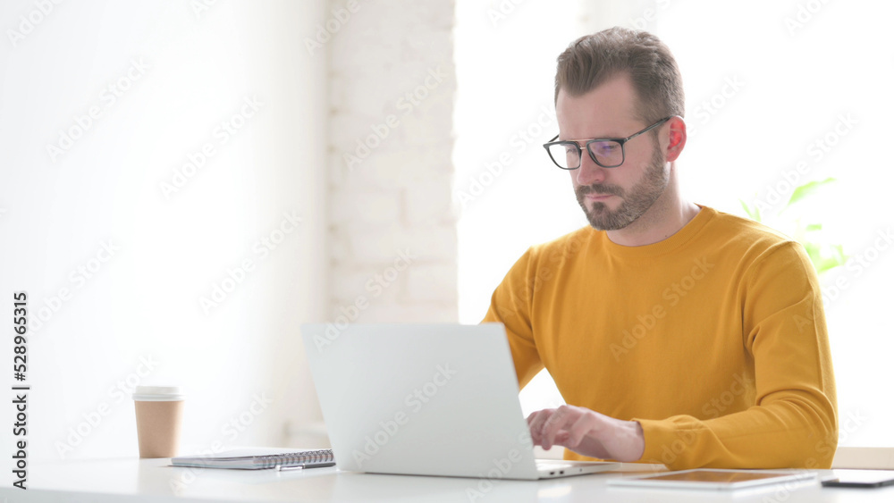 Man Working on Laptop in Office Man Working on Laptop in Office