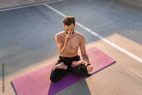 attractive hansome man with athletic strong body doing morning yoga dzen meditation © mary_markevich