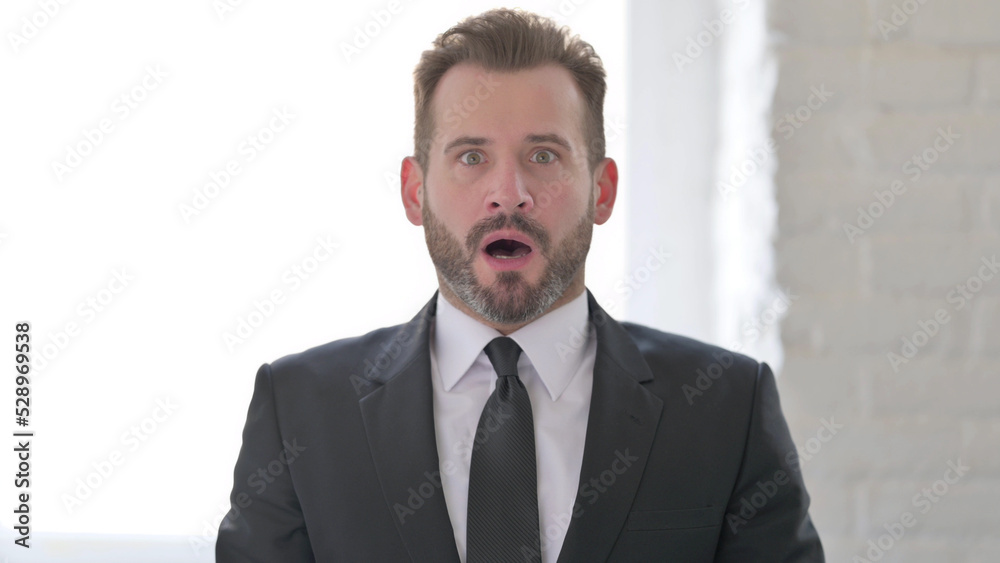 Shocked Middle Aged Businessman Wondering in Awe Shocked Middle Aged Businessman Wondering in Awe