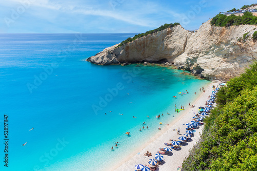 The magnificent Porto Katsiki beach on Lefkada Island, Greece. Beautiful landscape with sea coast, swimming people, trees, azure water.