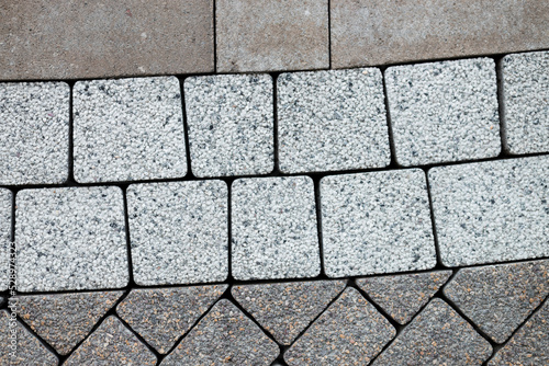 Grey brick stone street road. Light sidewalk  pavement texture