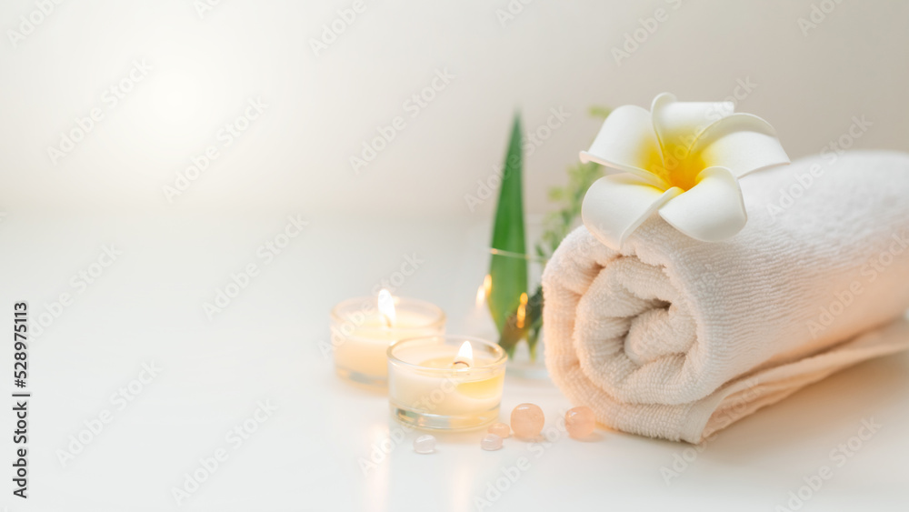 Still life spa setting with pink stone aroma scent candle and plumeria flower. Thai spa massage. Spa treatment cosmetic beauty. Aromatherapy care relax wellness. Aroma and salt scrub healthy lifestyle