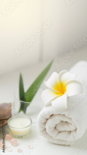 Still life spa setting with pink stone aroma scent candle and plumeria flower. Thai spa massage. Spa treatment cosmetic beauty. Aromatherapy care relax wellness. Aroma and salt scrub healthy lifestyle