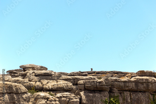lonely man taking a photo on top of the mountain
