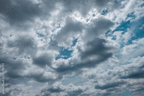 Texture of a blue sky with gray clouds