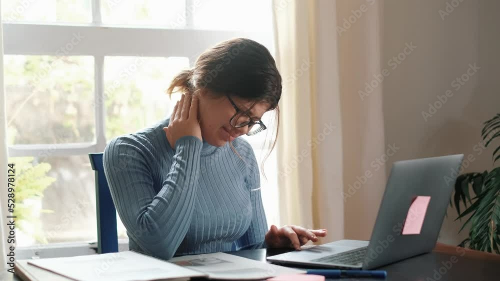 One young woman feeling bad and having pain for overstudying at home on the table. Neck ache concept. Portrait and close up of hands touching neck.
One young woman feeling bad and having pain for overstudying at home on the table. Neck ache concept. Portrait and close up of hands touching neck.