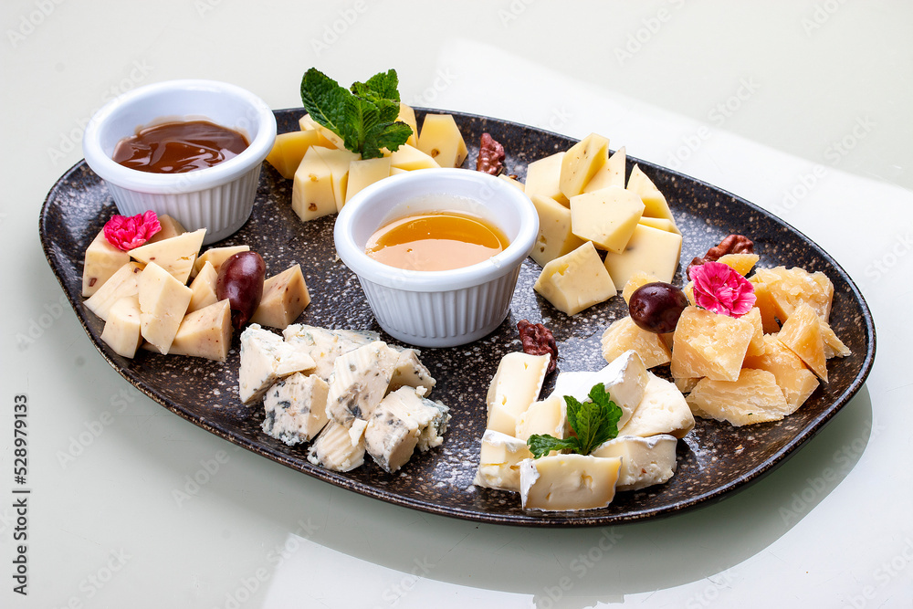 A plate with a variety of cheeses. A plate with a variety of cheeses.