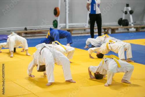 teenagers in kimono doing judo warm-up