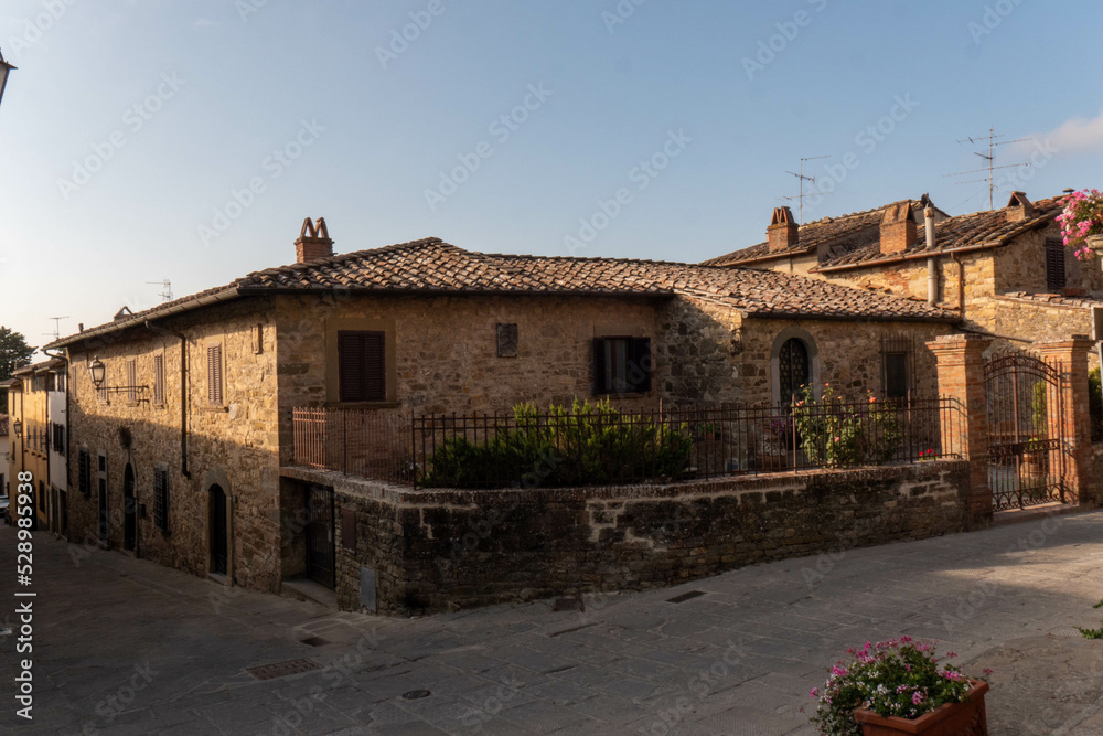 A quiet street of residential buildings in the historic medieval village of Panzano Tuscany