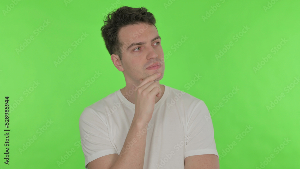 Thinking Young Man with New Idea on Green Background Thinking Young Man with New Idea on Green Background