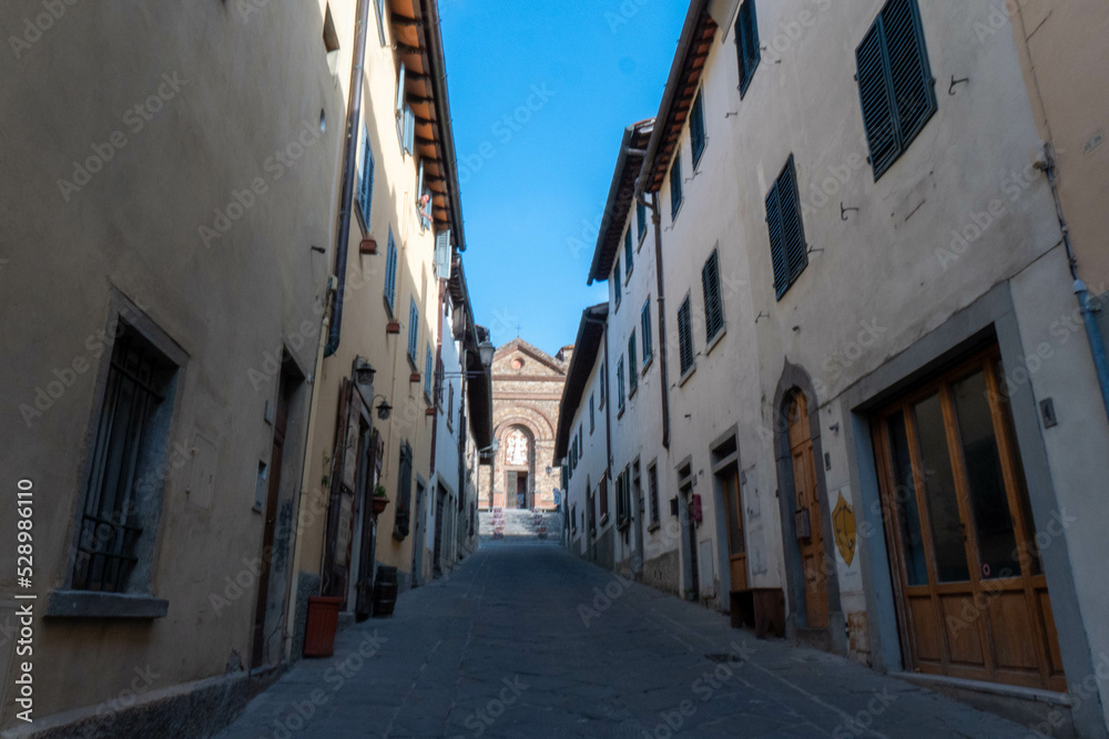 A quiet street of residential buildings in the historic medieval village of Panzano Tuscany