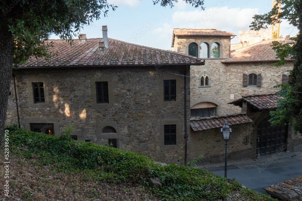 A quiet street of residential buildings in the village of Panzano Tuscany