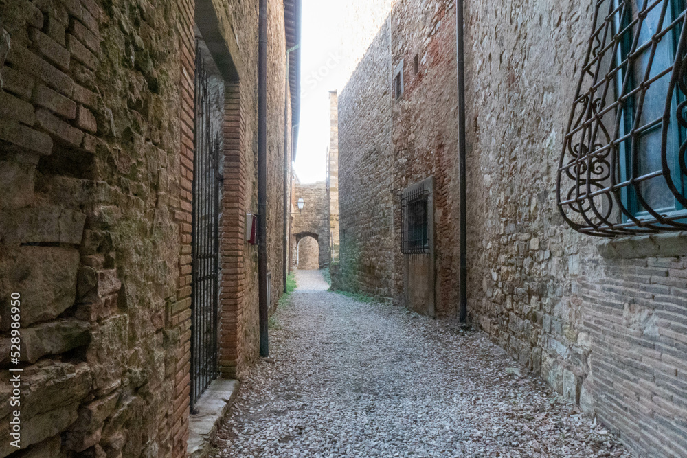 A quiet street of residential buildings in the village of Panzano Tuscany