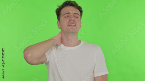 Young Man with Neck Pain on Green Background